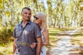 Portrait of senior family couple walking outdoors in summer forest. Elderly people hugging relaxing on date Royalty Free Stock Photo