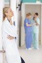 portrait senior female doctor on hospital corridor relaxing Royalty Free Stock Photo