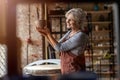 Senior female pottery artist in her art studio