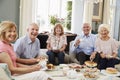 Portrait Of Senior Friends Enjoying Afternoon Tea At Home