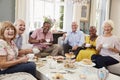 Portrait Of Senior Friends Enjoying Afternoon Tea At Home Royalty Free Stock Photo