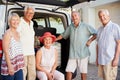 Portrait Of Senior Friends Loading Luggage Into Trunk Of Car About To Leave For Vacation Royalty Free Stock Photo