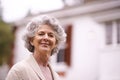 Portrait, senior and happy woman by house outdoor at backyard on retirement alone in Canada. Face, elderly and female Royalty Free Stock Photo