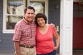 Portrait Of Senior Hispanic Couple Standing Outside House