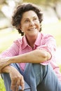 Portrait Of Senior Hispanic Woman Sitting In Park Royalty Free Stock Photo