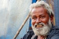 Portrait of Senior homeless poor Indian man seek help or alms at entrance of Hindu temple,