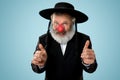 Portrait of an senior jewish man celebrating red nose day Royalty Free Stock Photo
