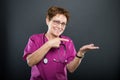 Portrait of senior lady doctor pointing copyspace area Royalty Free Stock Photo