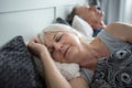 Senior lady sleeping in comfortable bed with husband Royalty Free Stock Photo