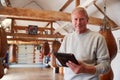 Portrait Of Senior Male Boxing Coach In Gym Tracking Training Using Digital Tablet Royalty Free Stock Photo