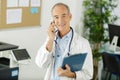 Portrait senior male doctor on telephone Royalty Free Stock Photo