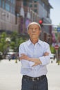 Portrait of senior man, arms crossed, outdoors in Beijing Royalty Free Stock Photo