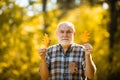 Portrait of senior man in the autumn park. Happy senior man. Portrait of a senior autumn man outdoors. Senior man hiking Royalty Free Stock Photo