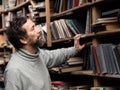 Portrait of senior man with beard on book market