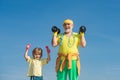 Portrait of senior man and cute child lifting dumbbells. Healthy family lifestyle. Funny old senior man and kid boy with