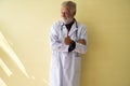 Portrait of senior doctor standing and showing thumb up at hospital,Happy and smiling positive thinking attitude,Copy space for te Royalty Free Stock Photo