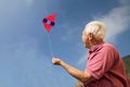 Portrait of senior man flying kite Royalty Free Stock Photo