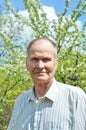 Portrait of senior man in garden looking at camera