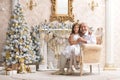 Portrait of senior man with granddaughter sitting in armchair Royalty Free Stock Photo