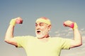 Portrait of senior man holding dumbbell. Like sports. Portrait of healthy happy smile senior. Grandfather sportsman Royalty Free Stock Photo