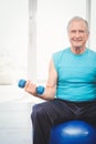 Portrait of senior man holding dumbbell Royalty Free Stock Photo