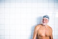 Portrait of a senior man in an indoor swimming pool. Royalty Free Stock Photo