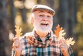 Portrait of a senior man outdoors walking in a park. Autumn and active holidays. Old man alone in autumn park. Senior Royalty Free Stock Photo