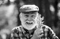 Portrait of a senior man outdoors walking in a park. Happy senior man looking at camera. Autumn and active holidays Royalty Free Stock Photo