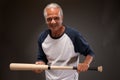 Portrait of a senior man posing with a baseball bat