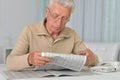 Portrait of senior man reading newspaper at home Royalty Free Stock Photo