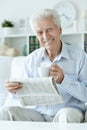 Portrait of senior man reading newspaper at home Royalty Free Stock Photo