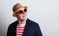 Portrait of a senior man with red sunglasses in a studio. Royalty Free Stock Photo