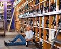 Portrait of senior man sitting on floor in winery tasting room, drinking red wine Royalty Free Stock Photo