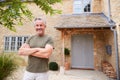 Portrait Of Senior Man Standing Outside Front Door Of Home Royalty Free Stock Photo