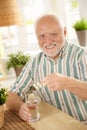 Portrait of senior man taking medicine at home Royalty Free Stock Photo