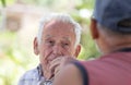 Two senior men talking in park