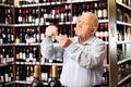 Portrait of senior man tasting red wine at wine shop Royalty Free Stock Photo