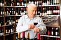Portrait of senior man tasting red wine at wine shop Royalty Free Stock Photo
