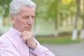 Portrait of senior man thinking about something outdoor Royalty Free Stock Photo