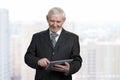 Portrait of senior man is touching tablet screen. Royalty Free Stock Photo