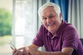 Portrait of senior man using mobile phone at home Royalty Free Stock Photo