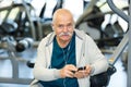 Portrait senior man wearing headphones in gym Royalty Free Stock Photo