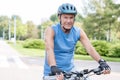 Portrait of senior man wearing helmet while riding bicycle in park Royalty Free Stock Photo