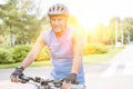 Portrait of senior man wearing helmet while riding bicycle in park Royalty Free Stock Photo