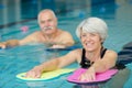 portrait senior man and woman in swimming pool Royalty Free Stock Photo