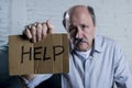 Portrait of senior mature old man on his 60s at home couch alone feeling sad suffering depression asking for help Royalty Free Stock Photo