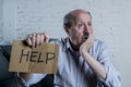 Portrait of senior mature old man on his 60s at home couch alone feeling sad and worried suffering pain and depression Royalty Free Stock Photo