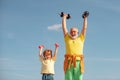 Portrait of senior man and cute child lifting dumbbells. Child raising a dumbbell. Senior man and child in family health