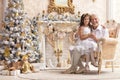 Portrait of senior man with granddaughter sitting in armchair Royalty Free Stock Photo