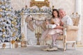 Senior man with granddaughter sitting in armchair Royalty Free Stock Photo